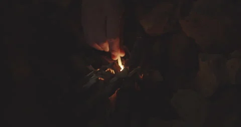 Hand Holding Lit Match In Bundle Of Firewood Stock Footage 145326461