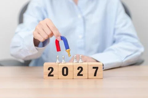 Hand holding magnet and pulling man chess figure from the crowd employee wi.. Stock Photos
