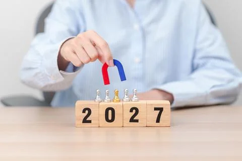 Hand holding magnet and pulling man chess figure from the crowd employee wi.. Stock Photos