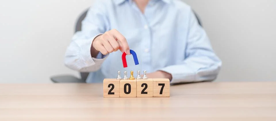 Hand holding magnet and pulling man chess figure from the crowd employee wi.. Stock Photos