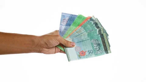 Hand holding malaysian ringgit banknotes over isolated white background Stock Footage 284280669
