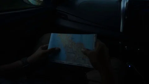 Hand holding a map of Thailand while driving when travelling to Thailand 스톡 동영상 104038382