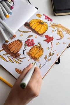 Hand holding marker while drawing autumn illustration Stock Photos