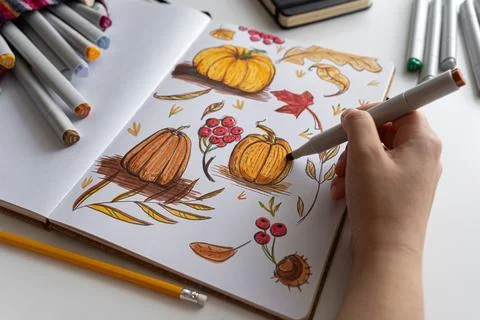 Hand holding marker while drawing autumn illustration Stock Photos