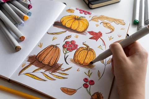 Hand holding marker while drawing autumn illustration Stock Photos