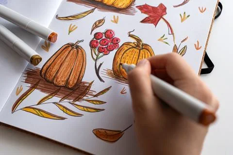 Hand holding marker while drawing autumn illustration Stock Photos