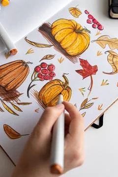 Hand holding marker while drawing autumn illustration Stock Photos