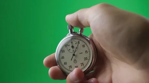 Hand holding a mechanical stopwatch against a green screen background Video stock 344331405