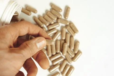 Hand holding medication Stock Photos