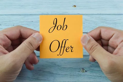 Hand holding memo note written with JOB OFFER. Stock Photos