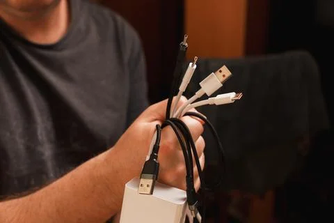 Hand holding a messy knot of electronic wires Photos
