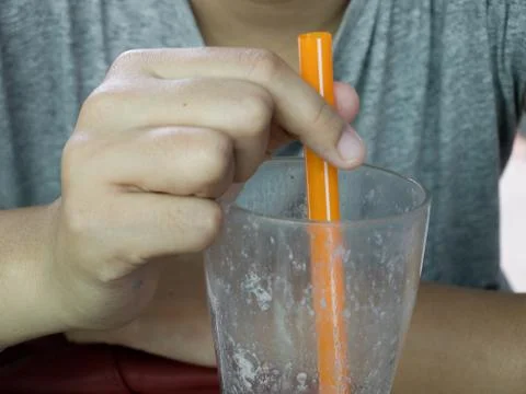 HAND HOLDING MILKSHAKE DRINKING STRAW Stock-Fotos