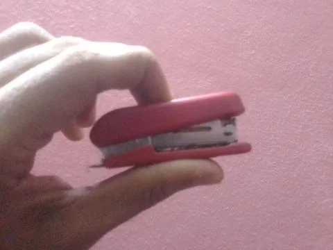 Hand Holding Mini Stapler mechine Stock Photos