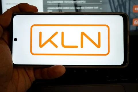 Hand holding mobile device displaying kln logo 写真素材
