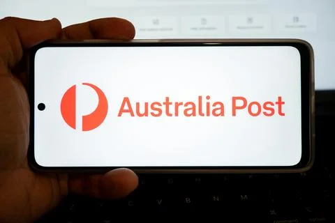 Hand holding mobile device displaying australia post logo Stock Photos