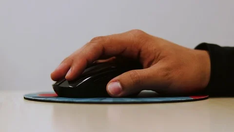 Hand holding a mouse and working in the office, it's only clicing Stock Footage 95662104