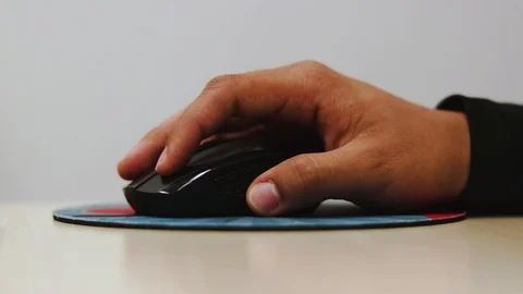 Hand holding a mouse and working in the office, dragging files Stock Footage 95663536