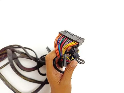 Hand Holding Multicolored Computer Power Connectors and Cables Stockfoto's