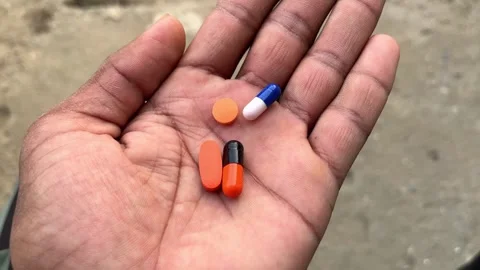 Hand Holding Multiple Tablets Close-Up for Health and Medication Concept Видео 321629811