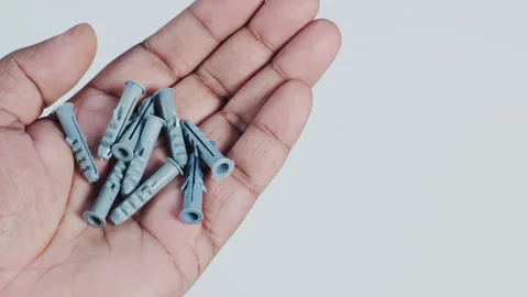 Hand Holding Nail and Screw Dowel Fasteners Stock Footage 248763842