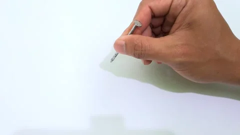 Hand holding a nail Stock Footage 292739936