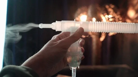 Hand holding Nebulizer Operation with Medication Vapor from Mouthpiece. Stock Footage 118674622