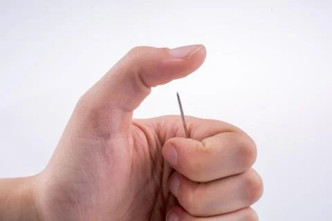 Hand holding a needle Foto stock