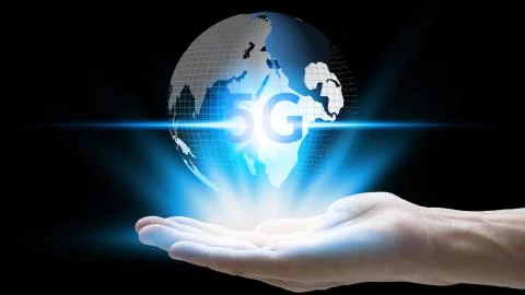 Hand holding network using 5G technology with virtual screen icons on a black Stock Photos