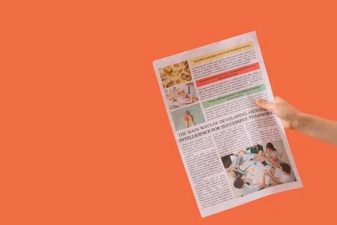 Hand holding newspaper with artificial intelligence teamwork article Stock Photos