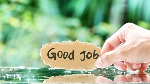 Hand-holding note with text Good Job on the glass reflection table Stock-Footage 268913104