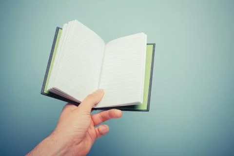 Hand holding notebook 스톡 사진
