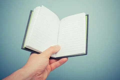 Hand holding notebook Stock Photos