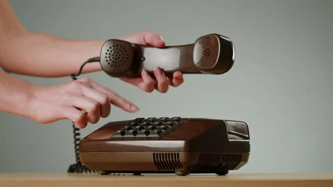 Hand Holding Old and Retro Telephone, Vintage Phone Headset isolated on grey Stock Footage 220886879