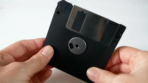 Hand holding the old computer floppy disks on white background Stock Footage 162818140