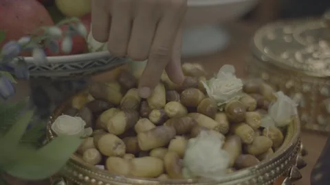 A hand holding Omani dates in a modern gathering Stock Footage 335923229
