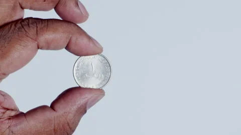 Hand Holding One U.A.E Dirham coin Stock Footage 248758567