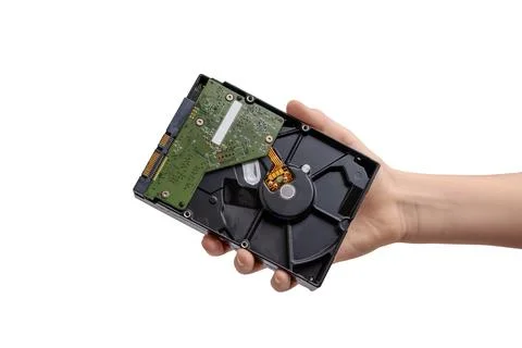 Hand holding opened hard disk drive showing internal platter and circuit bo.. Stock Photos