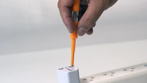 Hand Holding Orange Test Screwdriver Checks Electrical Socket for Current, .. Stock Footage 315406320