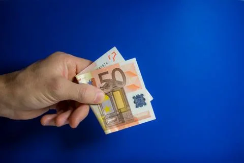 Hand holding out a banknote Stock Photos