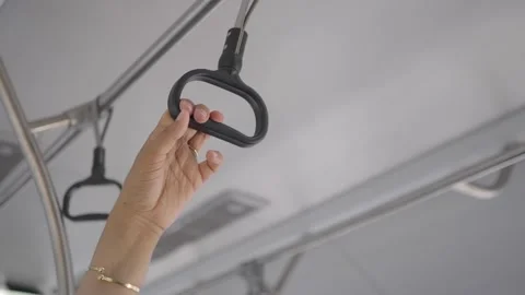 Hand Holding Onto Overhead Grab Handle on Public Transit Stock Footage 341997663