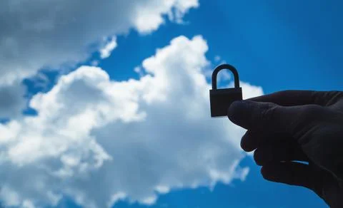 Hand holding padlock. Cloud computing. Cloud data security Stock Photos