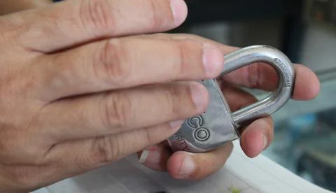 Hand Holding a Padlock Stock Photos