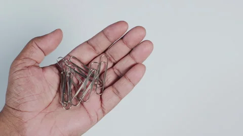 A Hand Holding Paper Clips Stock Footage 248766458