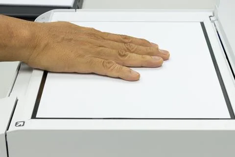 Hand holding a paper, inserting a scanner concept scanner 스톡 사진