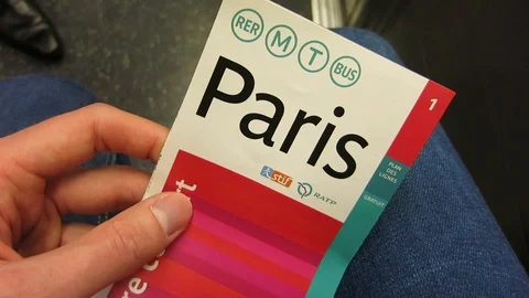 A hand holding the Paris metro map Stock Footage 117424415
