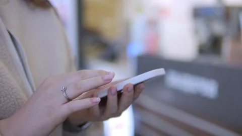 Hand holding phone with blurred background activity Stock Footage 342023792