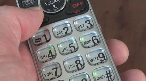 Hand holding phone while dialing with thumb Stockbeeldmateriaal 60992162