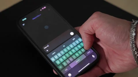 Hand Holding Phone While Typing on the Keyboard Stock Footage 293507647