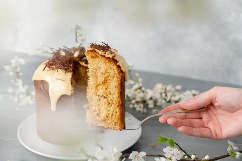 Hand holding piece of Easter cake on dessert spatula Stock Photos