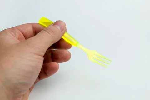 Hand holding a plastic fork. Stock Photos